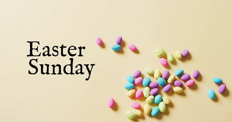 Image of eastersunday text over colourful easter eggs on yellow background