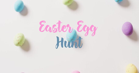 Image of easter egg hunt text over colourful easter eggs on white background