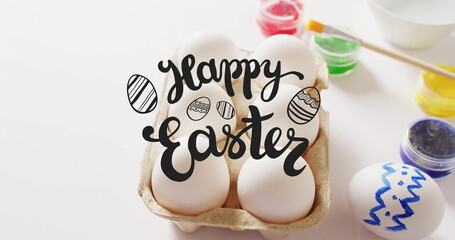 Image of happy easter text over eggs and paints on white background