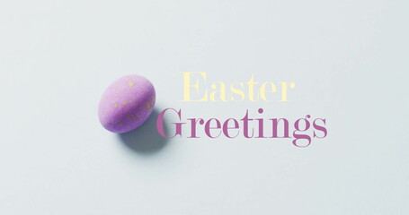 Image of happy greetings text over purple easter egg on bue background