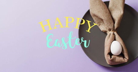 Image of happy easter text over white easter egg in cloth on purple background