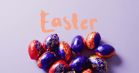 Image of easter text over colourful easter eggs on purple background