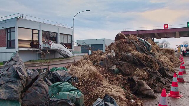 Semur-en-Auxois, FRANCE - JANUARY 16, 2026: Agricultural debris and soil cleared from A6 highway exit 23 following French farmers' protest. Road access restored after blockade at toll booth.
