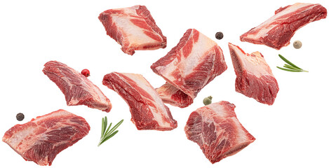 Falling raw beef rib pieces isolated on white background, full depth of field