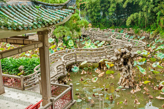 China - Macau - The beautiful pond curved stone trail among the lotus plants with the traditional chinese pavilion in the Lou Lim leoc garden, Sao Lazaro parish. Macau, China