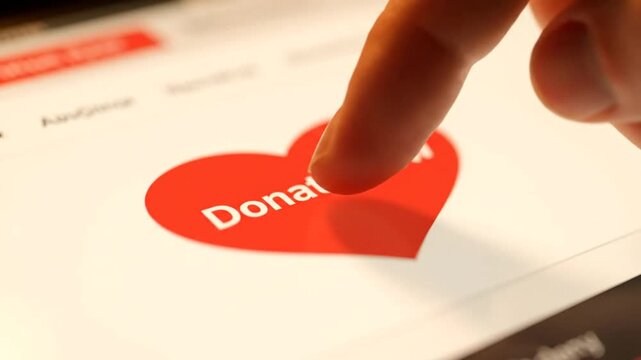 Finger Pressing Donate Now Heart Button Online.
