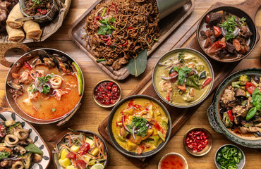 many different thai food dishes on table in modern restaurant in bangkok thailand