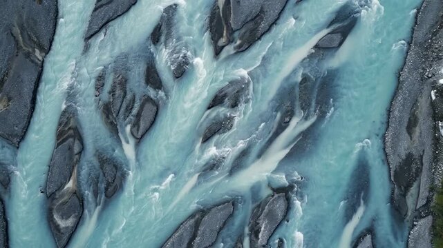 Aerial View of a Braided River: A captivating aerial perspective showcases the stunning natural beauty of a braided river system, its turquoise waters winding through a rocky landscape.