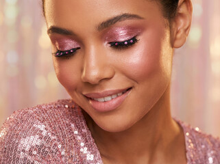 Close up portrait of a woman with a pink glittery trendy makeup 