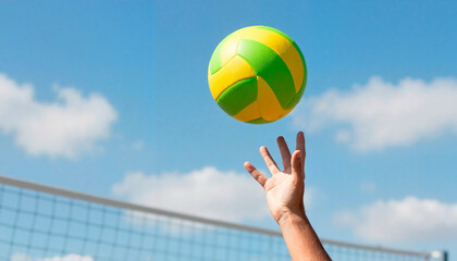 A man's hand catching a colorful volleyball against a blue sky background