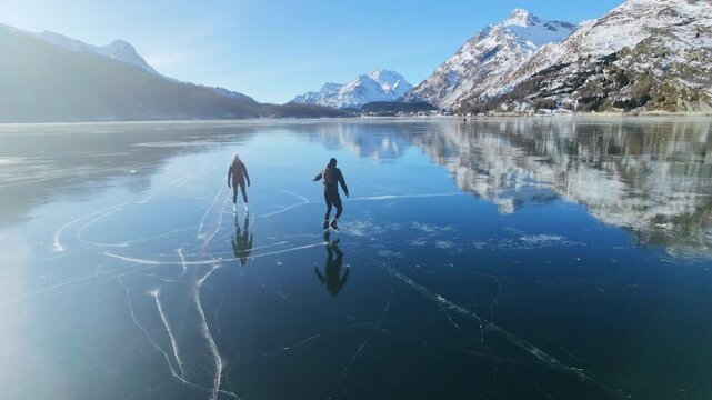 Woman and Man Skating on Mirror Ice, Sils Lake Switzerland