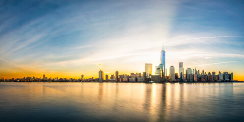New York city panorama at sunrise as viewed from Jersey City across Hudson River.