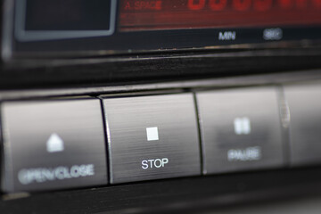 Obraz premium Closeup Of CD Player Stop Button On Metallic Dashboard Control Panel
