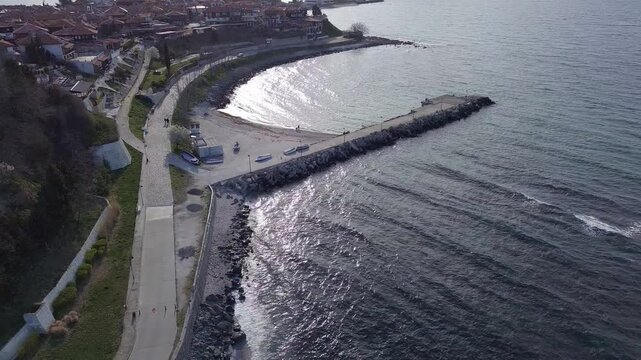 Aerial view of the city of Nessebar with parks and houses built up streets with people walking in Black Sea, Bulgaria