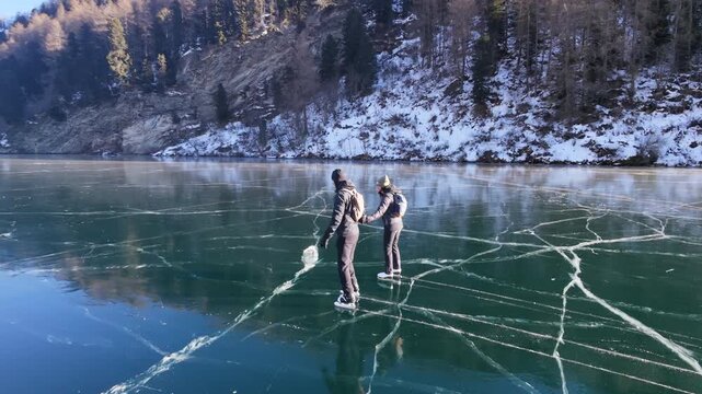 A couple iceskating Winter Silence: Ice Skating on Sils Lake, 4K Aerial