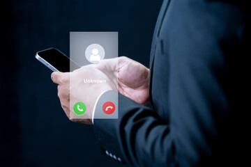 A businessman in a suit holds a smartphone featuring a digital interface for an unknown incoming call. Concept of privacy, communication, and digital security
