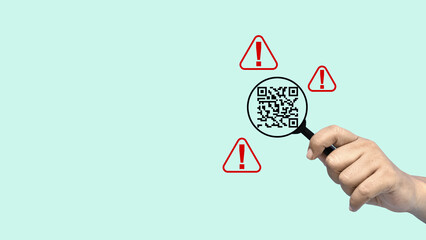 Hand holding a magnifying glass inspecting a QR code surrounded by red warning alert signs. Concept of quishing, cybersecurity, online fraud prevention, and scanning for malicious links