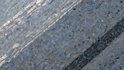 Abstract textured close-up of angled gray, blue, and black surface; diagonal lines