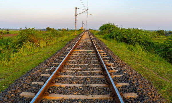 Landscape of railroad tracks in India cutting across rural countryside