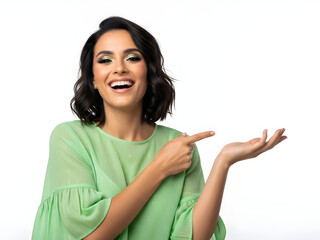 Cheerful young brunette woman grinning while pointing thumb to the side, wearing a mint green ruffled top, on a white background, suitable for approval, recommendation, or positive feedback illustrati
