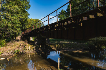 landscape with an old steel railway bridge crossing the river