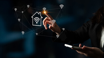 A close-up of a hand interacting with a virtual smart home interface, showcasing wireless signals and connectivity in a modern, dark environment focused on technology. Gantry