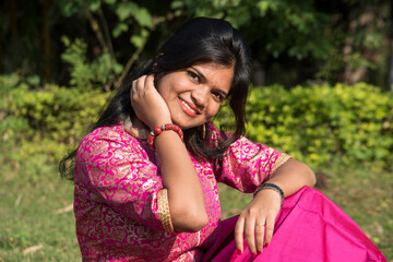 Fototapeta premium Outdoor portrait of beautiful young Indian girl in the park