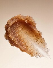 Hyper-realistic studio photography of cosmetic textures, swatch of a dark brown coffee sugar scrub on a beige gradient background