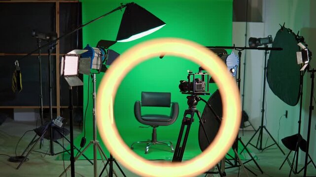 Professional video production studio with green screen and lighting equipment