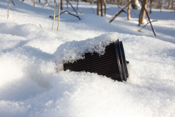 A plastic cup in the snow.