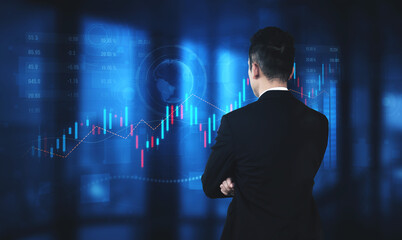A businessman stands in an office setting, analyzing stock market trends while surrounded by digital graphs and data charts in blue lighting, symbolizing strategic decision-making. Scalp