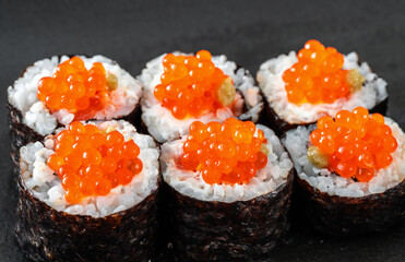 Close-Up of Sushi with Real Red Caviar on a Plate with Soy Sauce and Wasabi