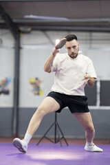 Fototapeta premium Determined man playing table tennis hitting ball