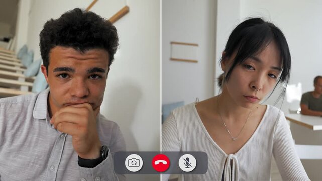 A man shows boredom during an online call. He rests his head on his hand while the other person is distracted. They both appear in their home spaces.