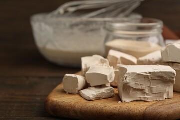 Different types of yeast and mixture on wooden table, closeup. Space for text