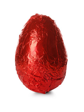 Chocolate egg wrapped in red foil isolated on white. Happy Easter