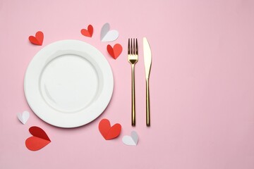 Beautiful table setting with decorative hearts on pink background, flat lay. Space for text