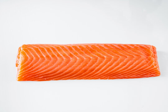 Piece of Raw Salmon Fillet for Sushi on a White Background
