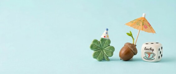 Festive lucky charms display with clover acorn and drink umbrella on soft blue background creative arrangement playful atmosphere artistic perspective conceptual inspiration