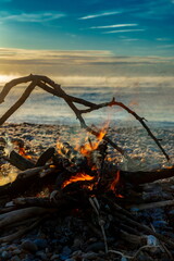 Fire on the beach at sunrise