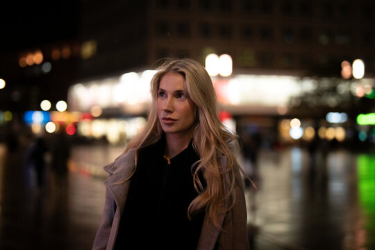 young woman walking in the night city