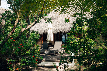 Luxury Beachfront Villa in the Maldives, Tropical Hideaway with White Sand and Palm Trees in Bright Summer Light
