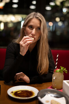 young woman eating a meal in the restaurant