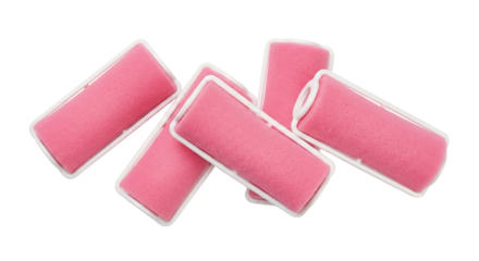 Set of pink foam hair rollers on a white background