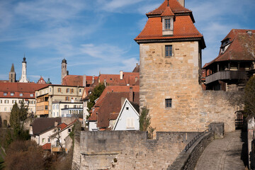Historic stone tower and old town buildings landscape
