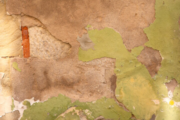 Peeling paint texture on weathered wall surface
