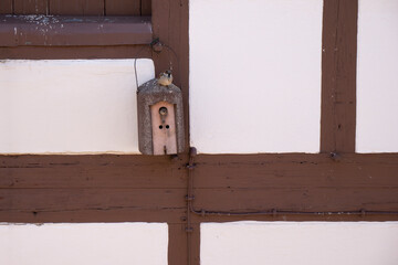Half timbered facade with decorative wooden birdhouses
