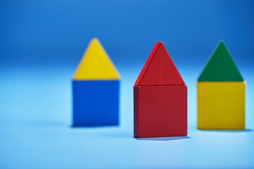 colorful wooden toy blocks making a row of tiny houses
