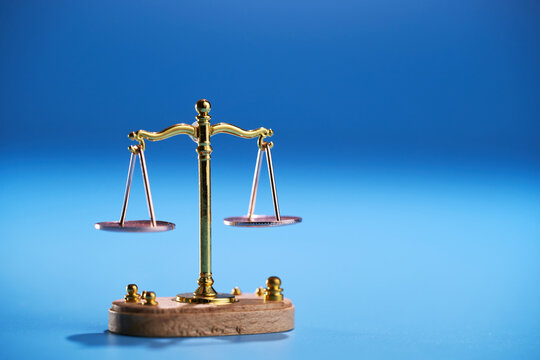 small libra scale on blue background