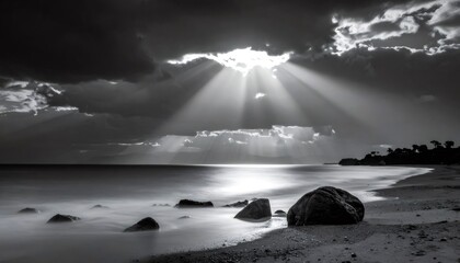 Sunbeams breaking through dramatic clouds on serene beach